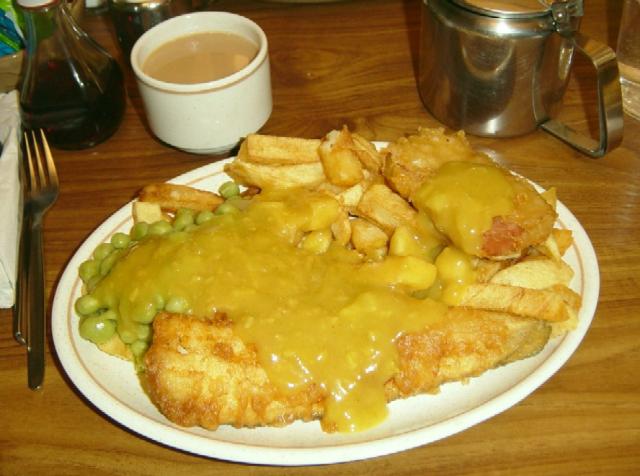 Fish, chips, mushy peas, a Spam fritter and curry sauce.