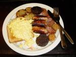 Sausage, black pudding, bacon, saute potatoes, scrambled egg on toast and something that could be breaded mushrooms.